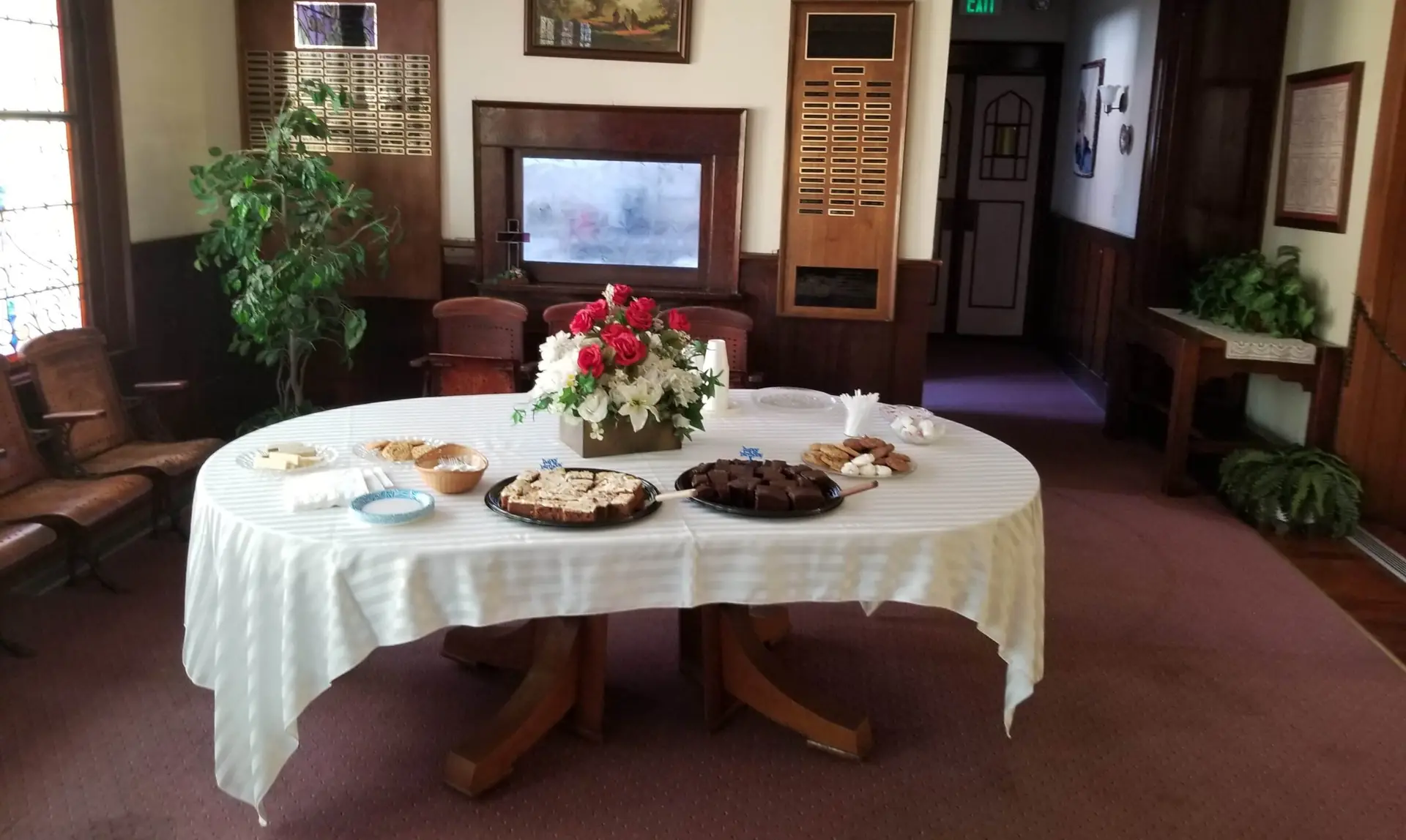 large table with white tablecloth and refreshments